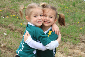 soccer sisters hugging after the game