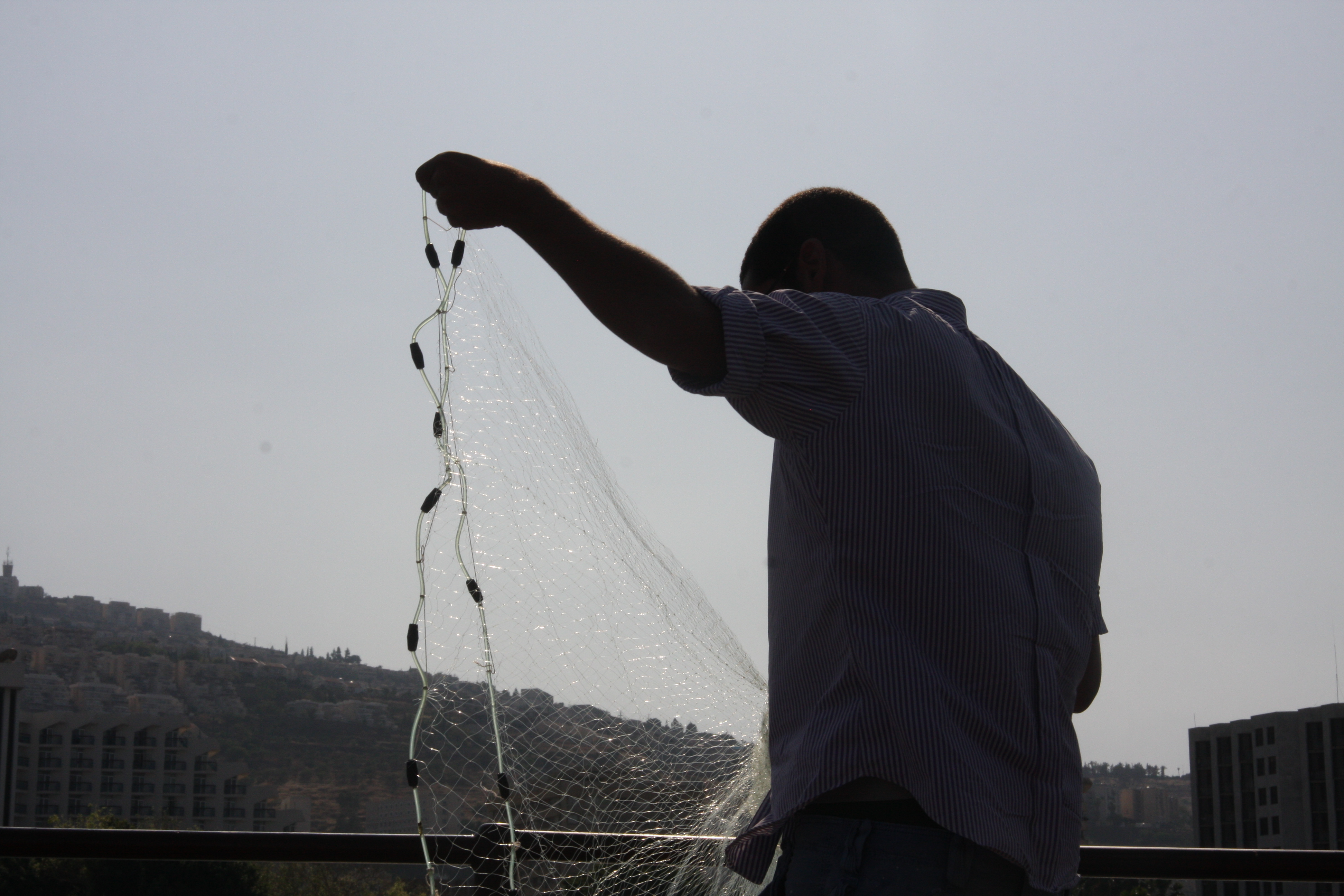 fisherman checking his net