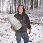 Jerry with an arm full of buckets for maple sap