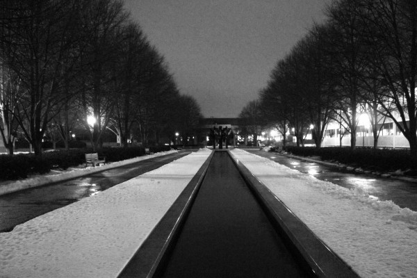 snow along a reflecting pond